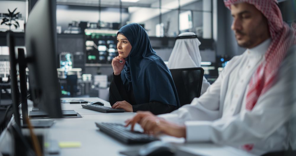 Portrait of a Thoughtful Middle Eastern Female Working on Computer in a Technological Corporate Office.