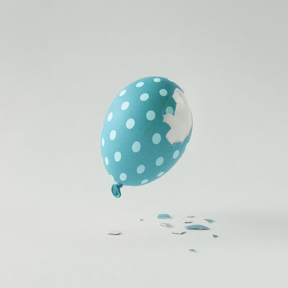 Polka dot blue Easter egg balloon on bright light background