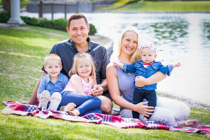 Happy Young Family Portrait In The Park