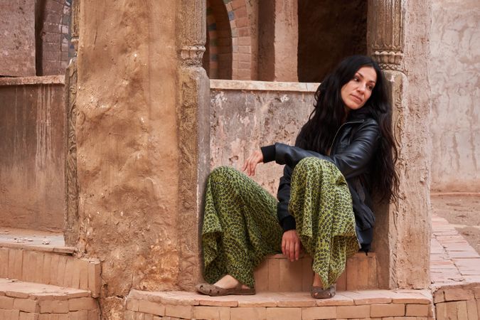 Woman on street between ancient buildings
