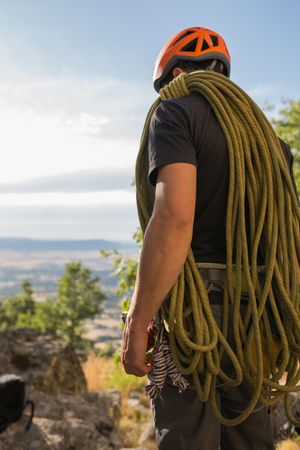 A climber is preparing his ropes to start climbing