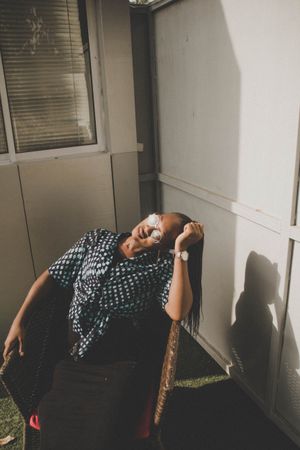 Woman leaning head while sitting