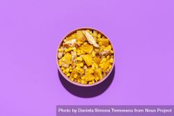 Pineapple chicken salad bowl, above view on a purple background 0V3kN5