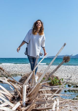 Young woman walking near dried plants