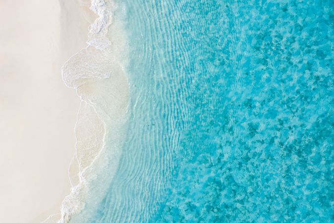 Overhead shot of a clear blue tropical beach in the Maldives