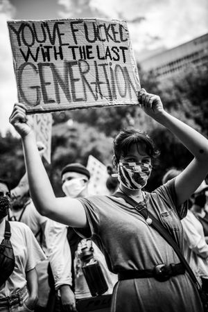 MONTREAL, QUEBEC, CANADA – June 7 2020- Woman holding a sign during protest in a group of people