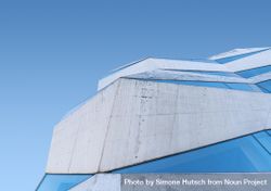 Side of geometric building against a blue sky 5nYqD0