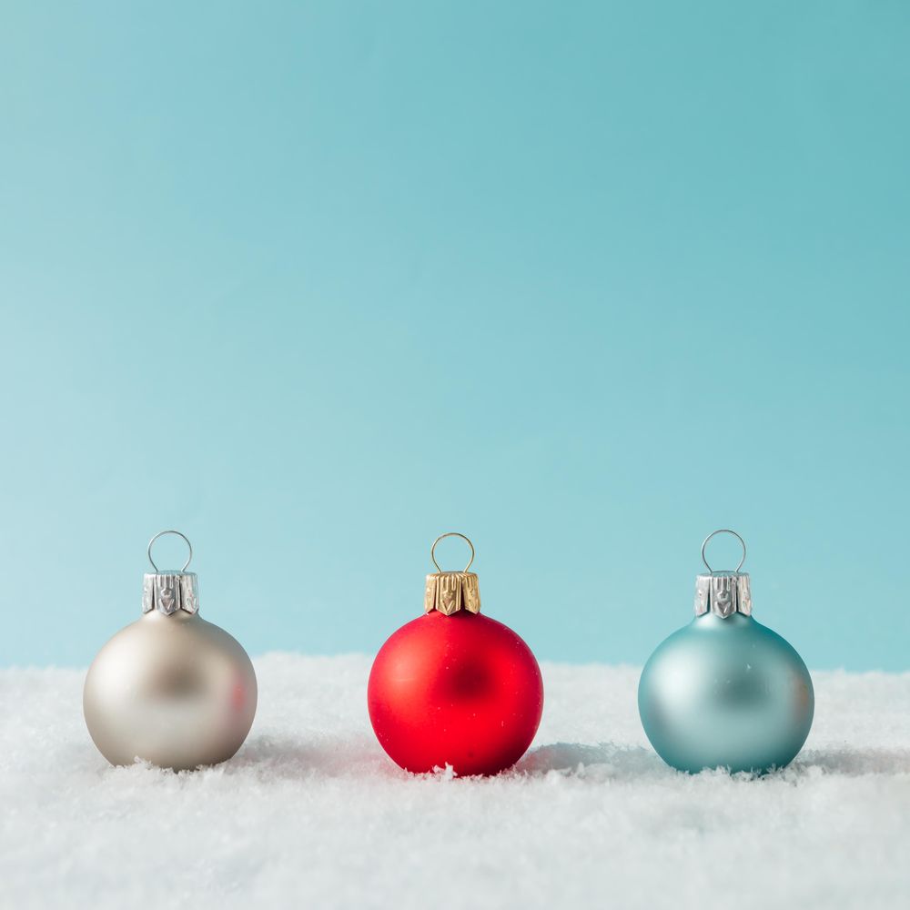 Row of Christmas bauble decorations on snow