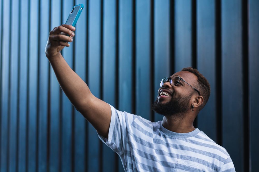 Happy man taking selfie on smartphone