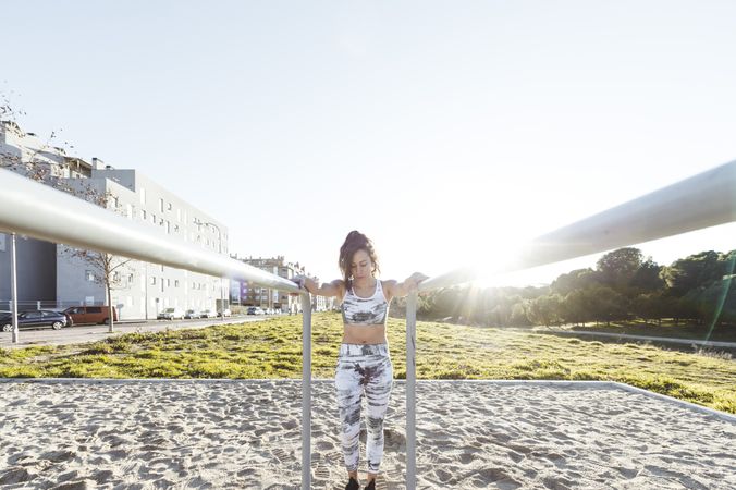 Young woman training on parallel bars