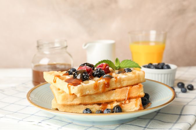 Composition of breakfast with belgian waffles, space for text