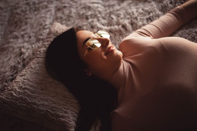 Young woman lying on bed