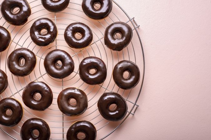 Close up of fresh donuts with melted chocolate set to cool