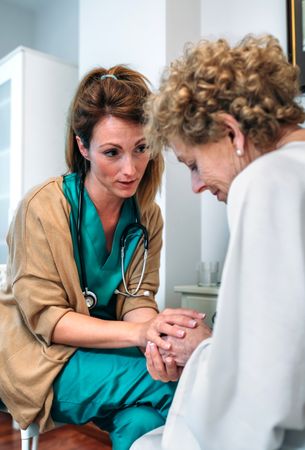Doctor giving encouragement to mature patient