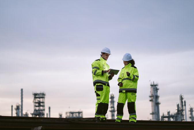 Engineer worker watching work monitor on digital tablet and checking at factory