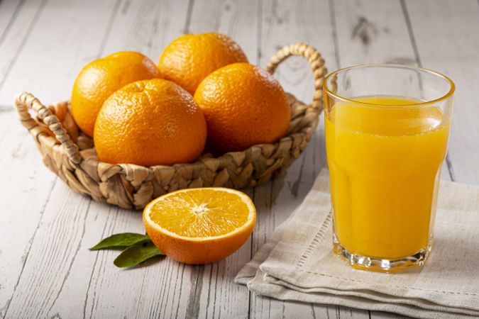 Glass with orange juice on the table.