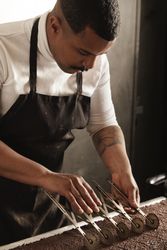 Black male chef working in professional pastry kitchen