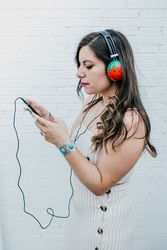 Woman in bright headphones listening to music
