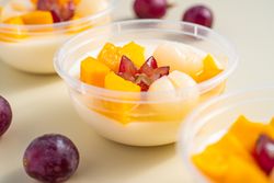 Three bowls of pudding fruit with a flower like shape from grape