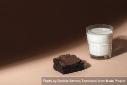 Glass of milk and brownie cookie in sunlight 5z9DP0