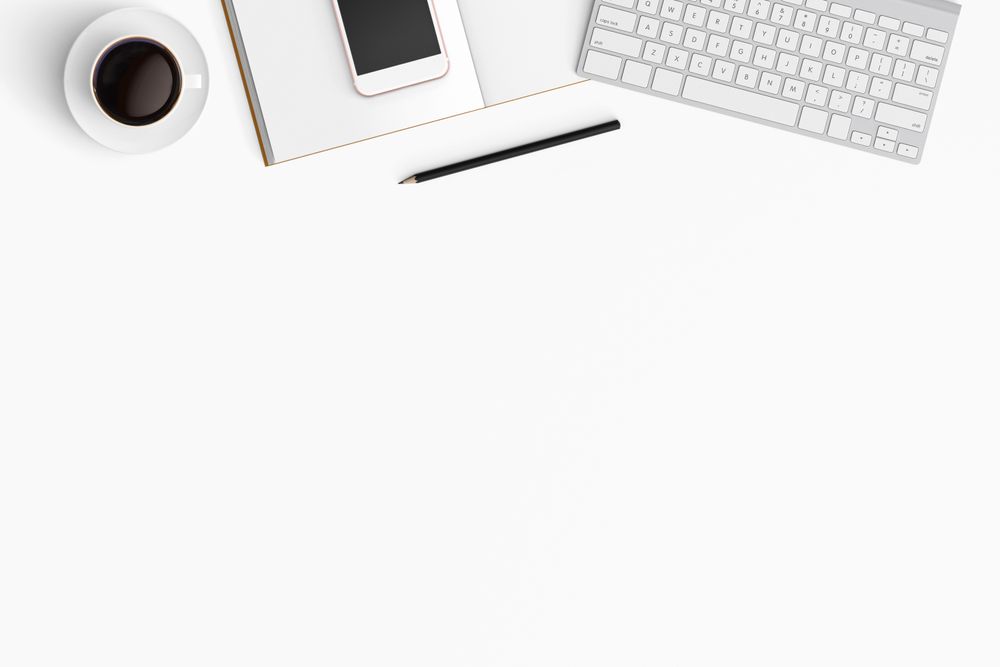 Modern workspace with coffee cup, smartphone, paper, notebook, tablet and laptop copy space
