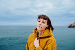 Young woman standing near sea