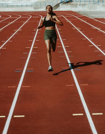 Woman runner training on a running track