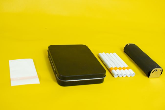 Yellow table with cigarettes and papers