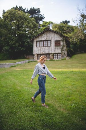 Content female walking on grass in countryside