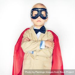 Serious blond boy wearing airplane goggles and cape 416pgb