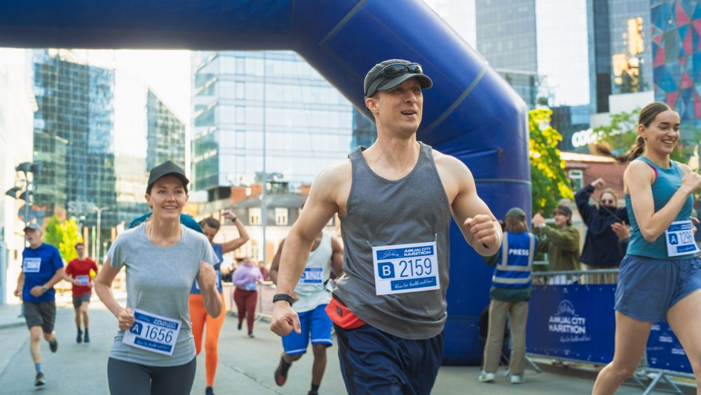 Friendly Happy Male Runner Celebrating Crossing the Finish Line in a Race