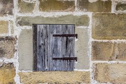 Stone wall with a wooden trapdoor