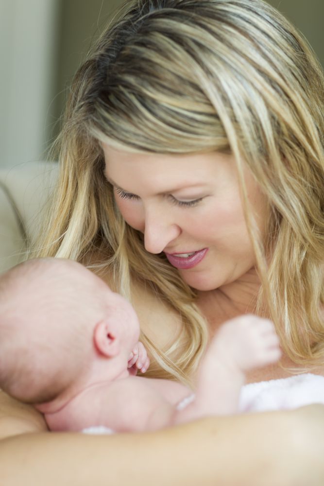 Happy Mother Holding Her Precious Newborn Baby Girl