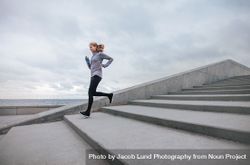 Healthy sports woman running down the stairs 4mWvlo