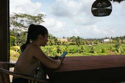 Woman using Mobile Phone with a beautiful landscape