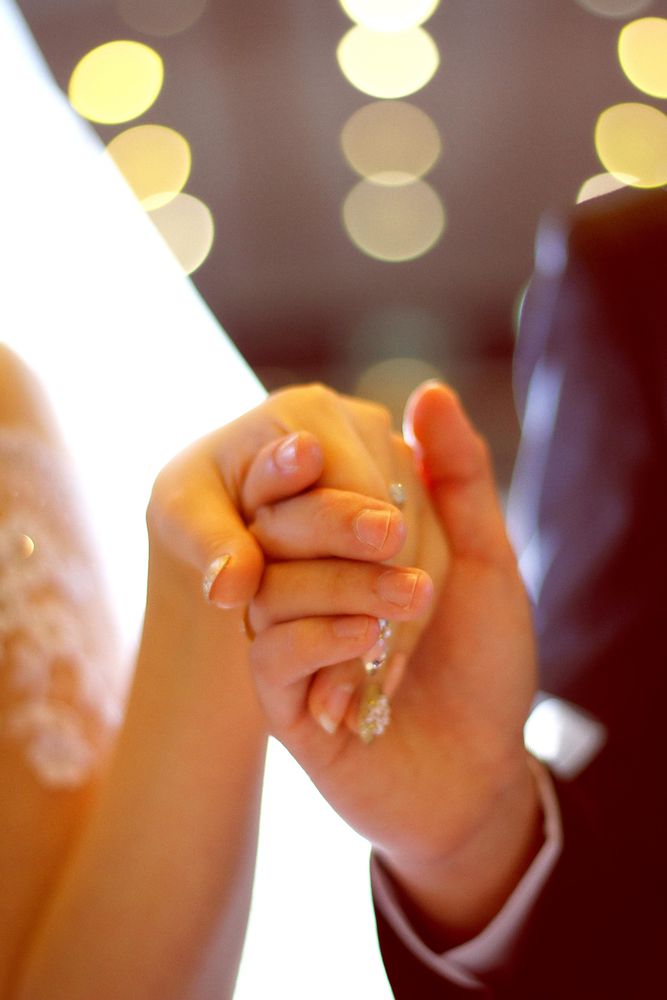 Bride and groom holding hands