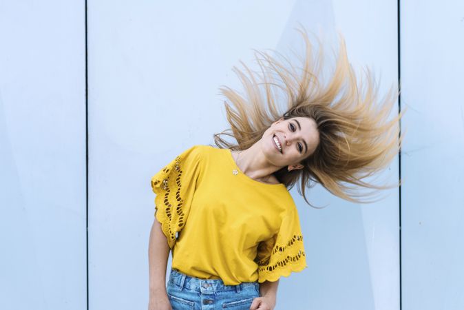 Young woman shaking hair