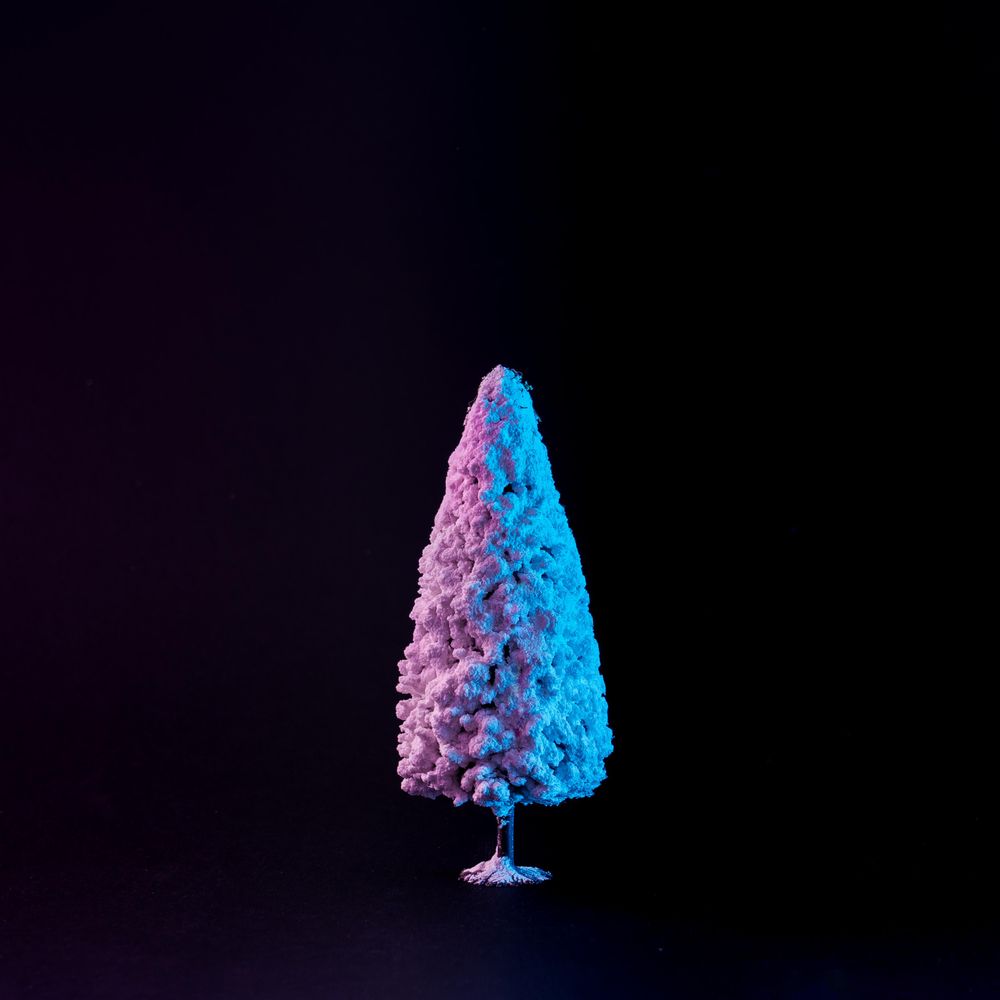 Snowy Christmas tree in vibrant bold gradient holographic colors