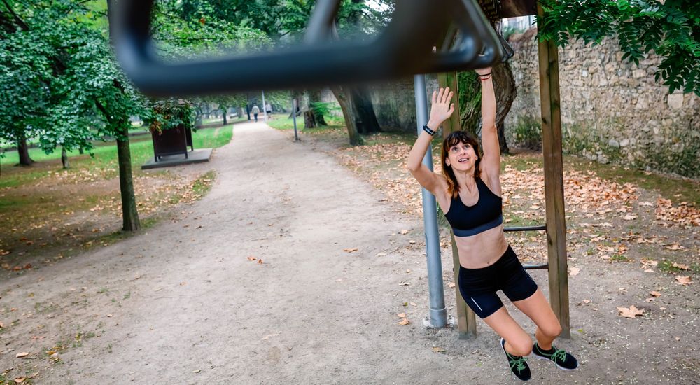 Woman doing monkey exercises on rings