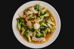 Cooked appetizing soup with squid and vegetables