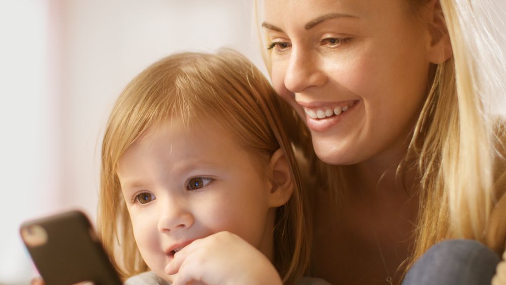 Mother Shows Her Daughter Something Interesting in It.