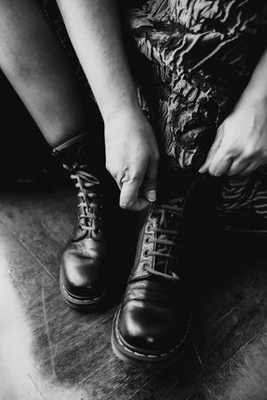Woman in dress lacing boots