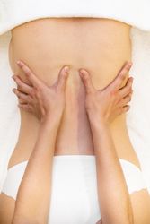 Top view of female receiving a back massage in a spa center