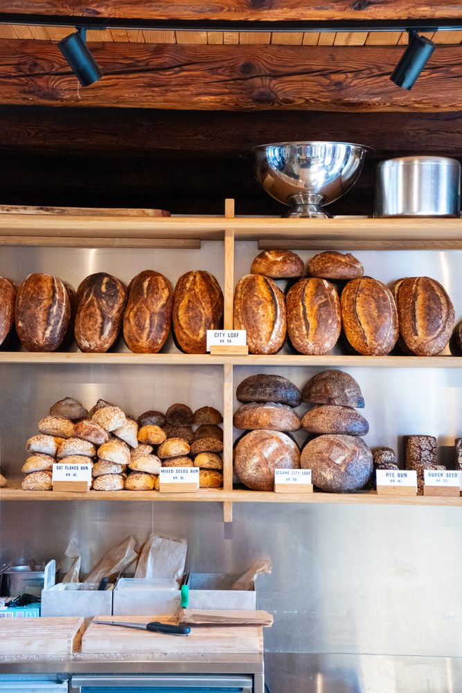 Boules of bread on shelves for sale in bakery