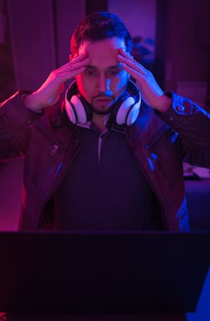 Man listening cheerfully to music with headphones.