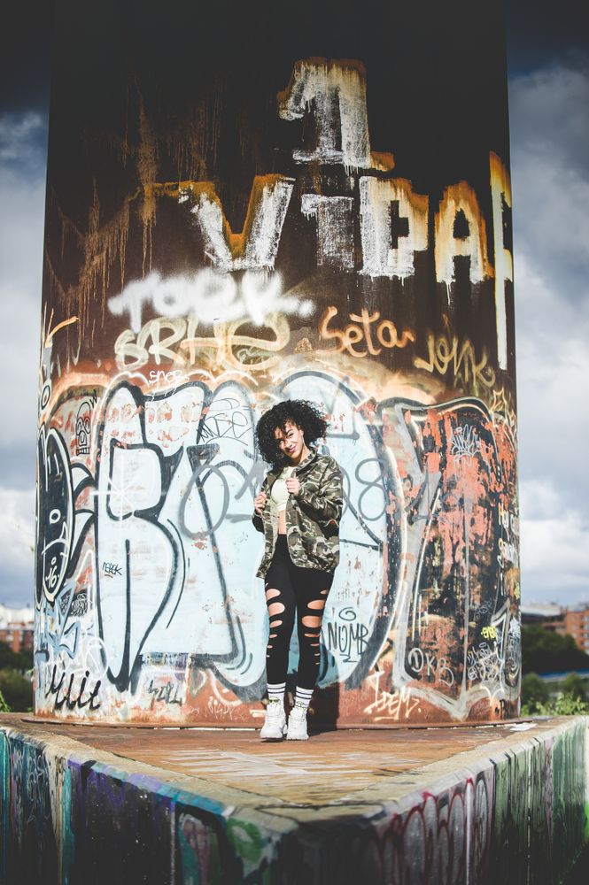 Black woman laughing in an urban environment
