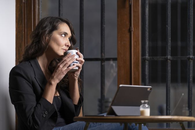 Young female using digital tablet in cafe