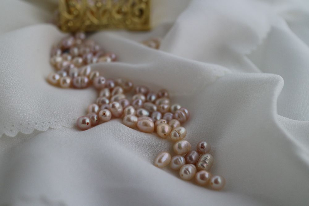 Close up of freshwater cultured pearls on satin silk