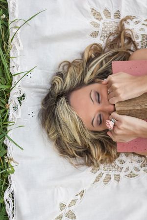 woman with book on the grass