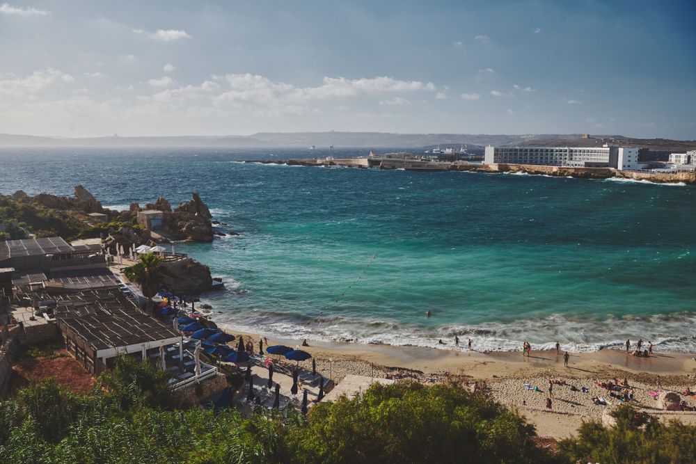 View of small cove with beach goers enjoying the sun and water